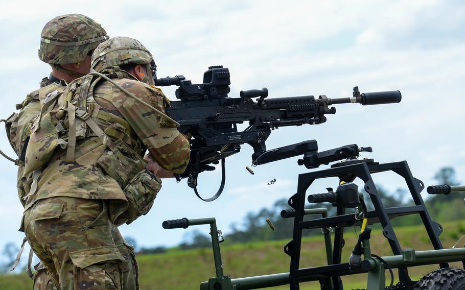 Soldiers competing in the Army’s Best Ranger Competition fire a machine gun at Fort Benning, Ga., on Friday, April 14, 2023. 