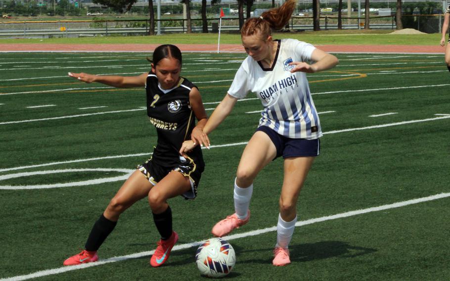 Humphreys' Kiana Perez and Guam High's Amelia Desiderio battle for the ball.