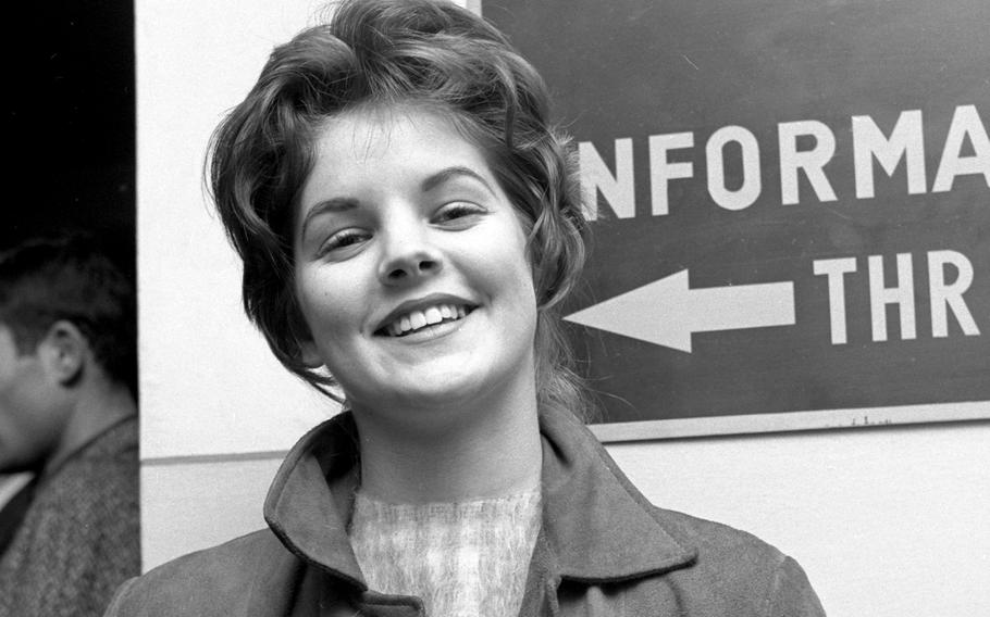 A black-and-white image shows a teenage Priscilla Baulieu, who who later married Elvis Presley and became Priscilla Presley.