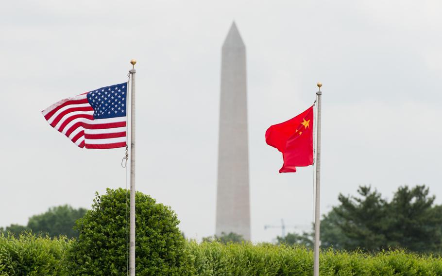 U.S. and Chinese flags fly before a full-honors welcome ceremony for a Chinese general outside the Pentagon in Arlington, Va., on May 15, 2014. 