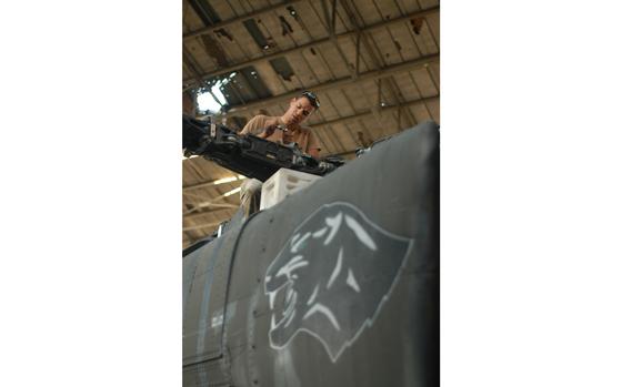 Kandahar Airfield, Afghanistan, March 27, 2004: Spc. Jonathan Stormm of the New York National Guard works to take the drive plate off the rotor head of an AH-64 Apache belonging to the 1st Battalion, 130th Aviation Regiment of the North Carolina National Guard.  The aircraft was going through maintenance. Stormm and another soldier from New York volunteered to deploy with the Raleigh-Durham-based unit. 

META TAGS: Afghanistan, Operation Enduring Freedom, War on Terror, New York National Guard; 