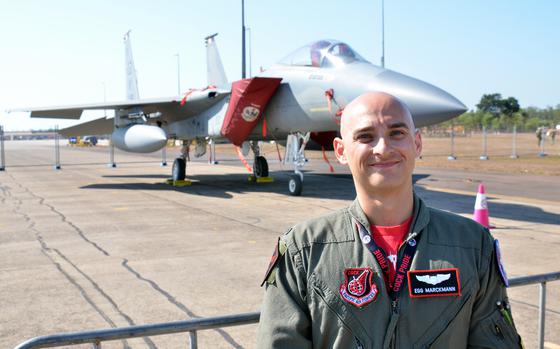 Air Force 1st Lt. Trevor Marckmann poses with an F-15 Eagle at Royal Australian Air Force Base Darwin, Saturday, Aug. 27, 2022. Six F-15s from the 67th Fighter Squadron at Kadena Air Base, Okinawa, are in Australia for the Pitch Black exercise. 