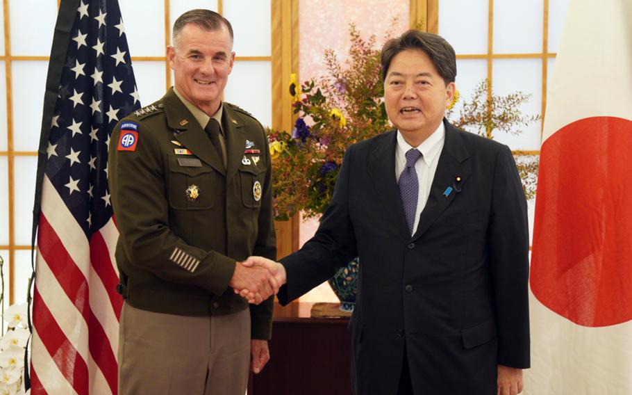 U.S. Army Pacific commander Gen. Charles Flynn poses with Japan's foreign affairs minister, Yoshimasa Hayashi, in Tokyo, Friday, Sept. 9, 2022.