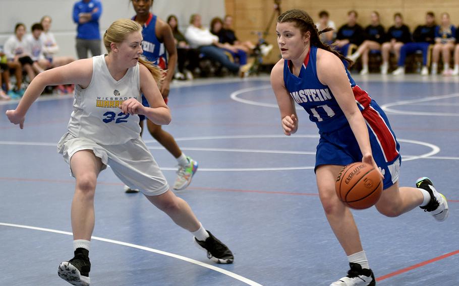 Ramstein's Katya von Eicken, right, dribbles as Wiesbaden's Gwen Icanberry defends during pool play of the Division I DODEA European Basketball Championships on Wednesday at Ramstein High School on Ramstein Air Base, Germany.