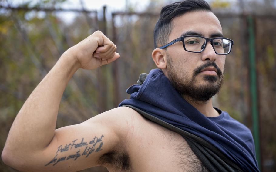 Angel Luna, an American veteran who traveled to Ukraine after the Russian invasion in 2022, shows off his tattoo which reads “Protect Freedom, not just for your country but for all” while at a training site outside of Kyiv on Oct. 27, 2022. Luna, who served in the North Carolina National Guard, quit his job in a Walmart warehouse to join Task Force Yankee Ukraine, a group which provides humanitarian aid and medical training to Ukrainians. 