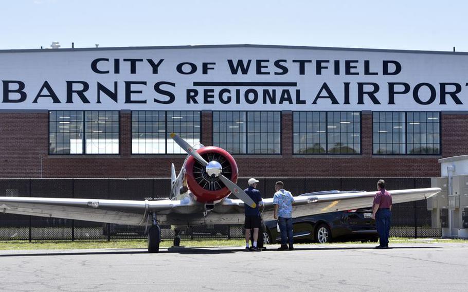 Guests view a 1940s era T6 Texan Advanced Trainer plane during the AirPower History Tour at Westfield-Barnes Regional Airport.