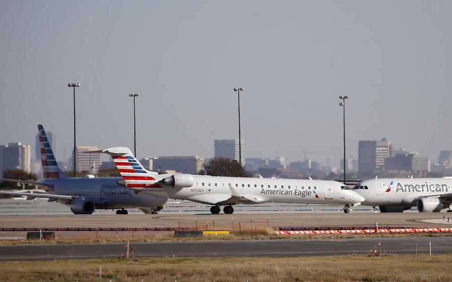 American Eagle and American Airlines planes make their way toward the runway before taking off at Dallas Fort Worth International Airport on Monday, Nov. 16, 2020, in Dallas. 