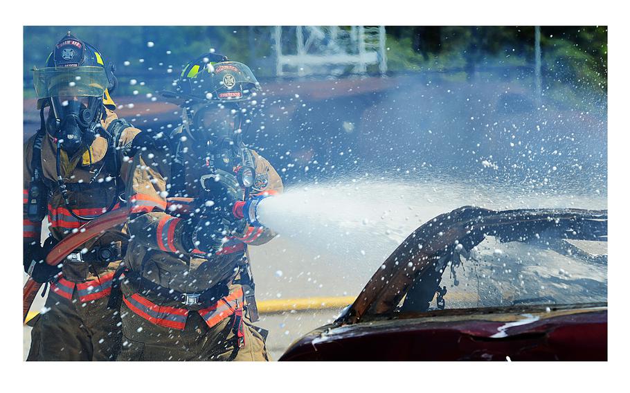 U.S Airmen extinguish a controlled car fire using compressed air foam at Shaw Air Force Base, S.C., on March 10, 2014.