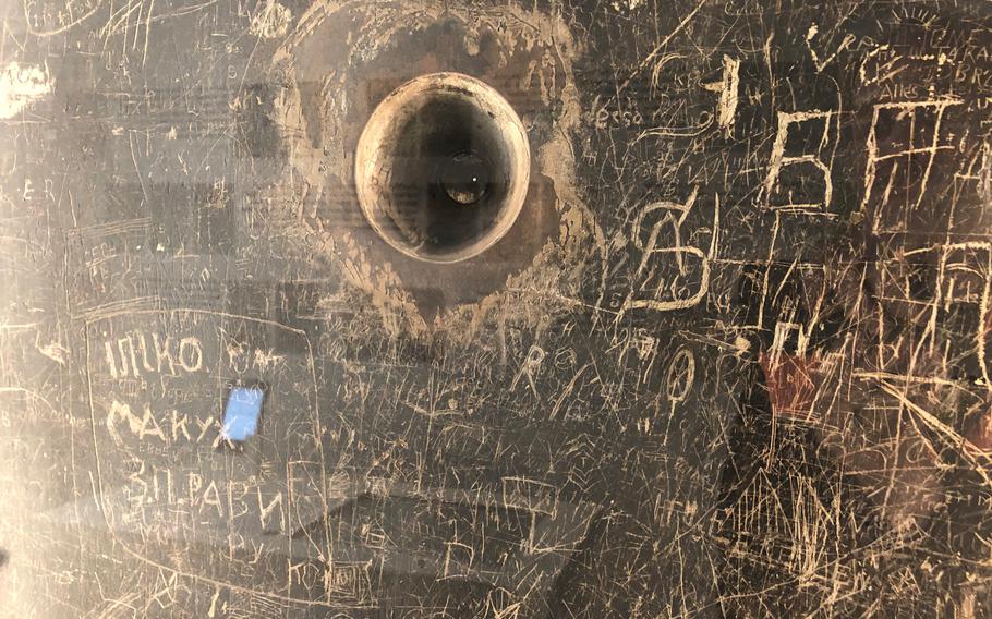 This is an up-close look at some of the markings carved into the cell door on display at the Hotel Silber museum in Stuttgart, which is focused on the role of the Gestapo during the Nazi era.
