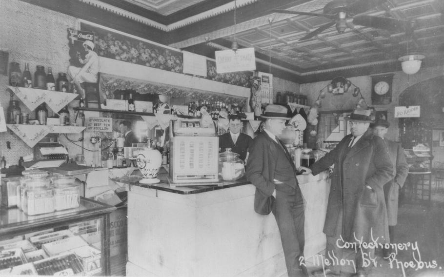 A couple of “gangsters”  possibly loiter at Lancer’s Confectionery, 2 E. Mellen St., in 1930, during Prohibition. The saloon that was the Richelieu had been converted into a “confectionery” when Prohibition came to Virginia in 1916. Historians consider it likely that the joint still served up alcohol on the sly.