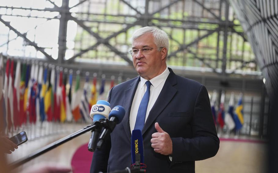 Ukraine’s Foreign Minister Andrii Sybiha speaking to reporters at European Council building.