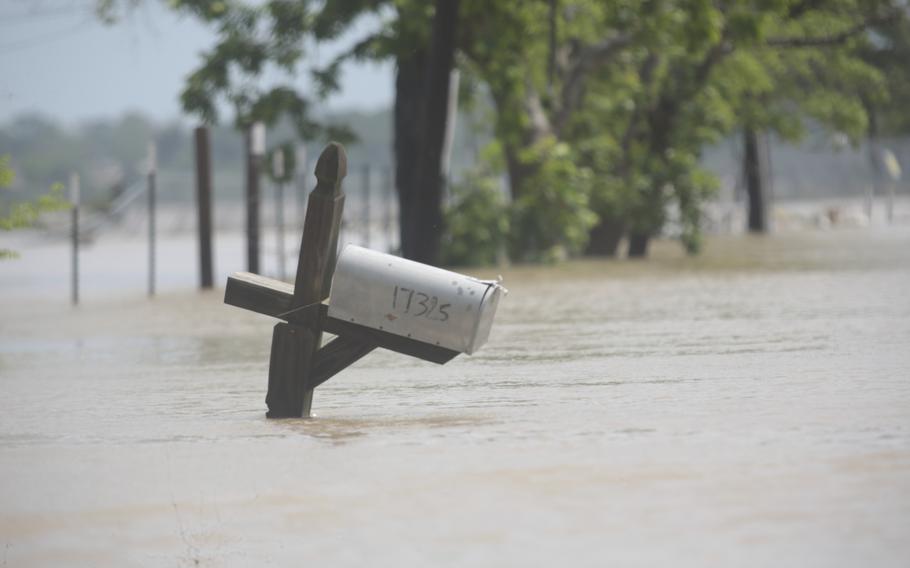 A mailbox is partially submerged on a flooded street in an unincorporated area in east Harris County near Houston on Sunday morning, May 5, 2024. 