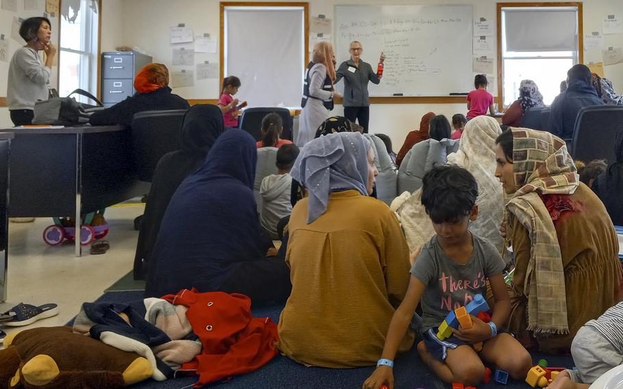 Afghan women and children learn English words in a morning at class at Fort McCoy, Wis., on Sept. 28, 2021.