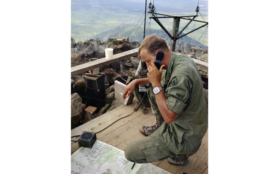 A soldier calls in artillery strikes on the surrounding flatlands and hills