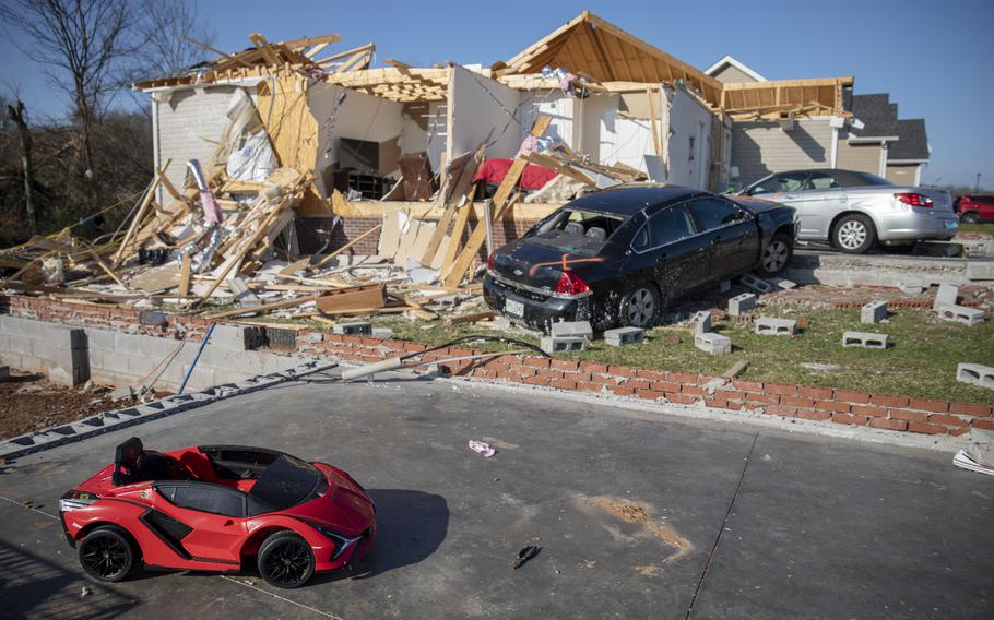 A child’s toy car sits near damaged cars and homes Tuesday, Dec. 14, 2021, in Bowling Green, Ky., after a tornado touched down in the middle of the night. According to three different reports released Monday, Jan. 10, 2021, the United States staggered through a steady onslaught of deadly billion-dollar climate disasters in an extra hot 2021, while the nation’s greenhouse gas emissions last year jumped 6% because of surges in coal and long-haul trucking, putting America further behind its 2030 climate change cutting goal.