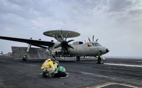 The flight deck crew prepares to launch an E-2 Hawkeye command and control plane off the deck of the aircraft carrier USS Dwight D. Eisenhower on March 19, 2024.