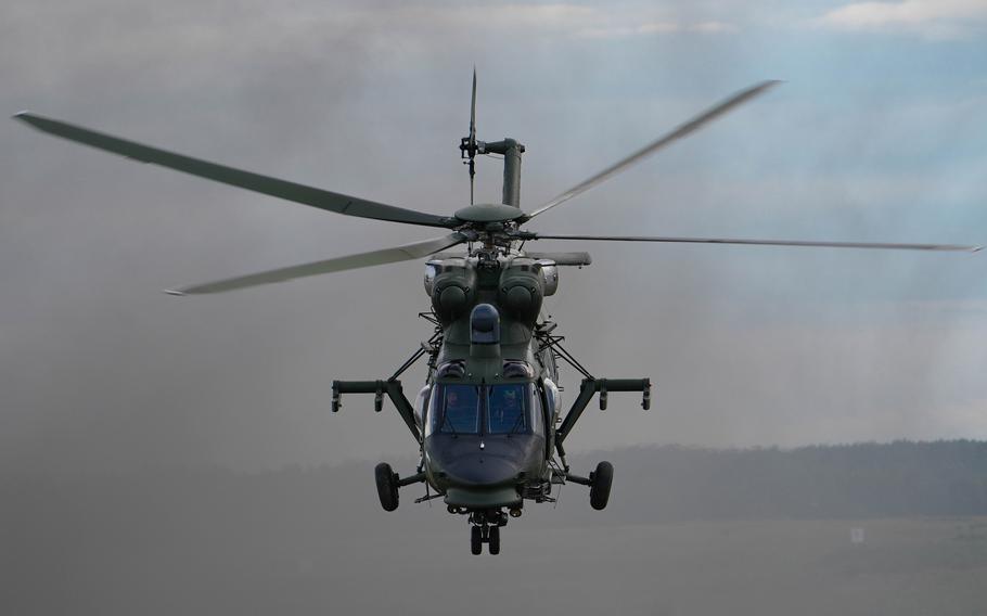 A Polish W-3 Sokol helicopter soars overhead.