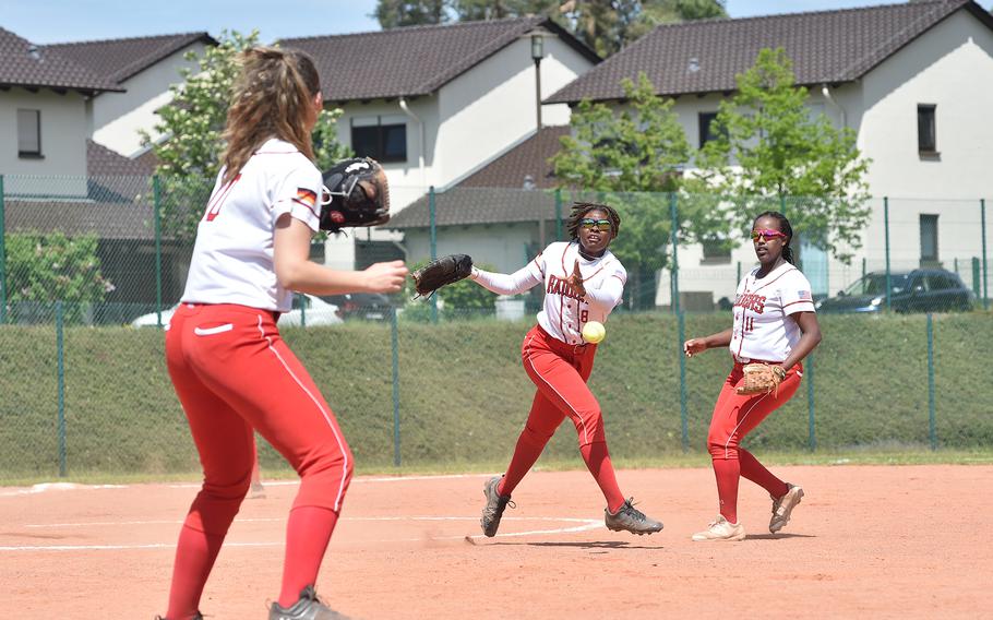 Kaiserslautern pitcher Aries Garrett throws the ball to first baseman Marika Campbell, left, during a Division I DODEA European softball quarterfinal against SHAPE on May 19, 2023, on Ramstein Air Base, Germany.
