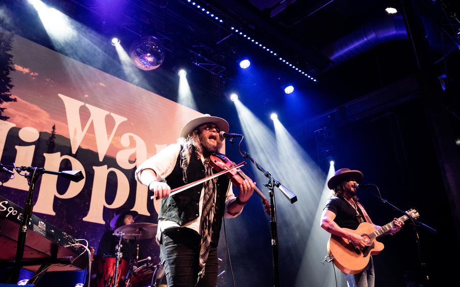 Country music duo War Hippies performs March 9, 2023, at MadLife Stage & Studios in Woodstock, Ga., just north of Atlanta, during their 2023 tour in support of their self-titled debut album. Both War Hippies members, Marine veteran and guitarist Scooter Brown, right, and Army veteran and violinist Donnie Reis, left, are Iraq War veterans.