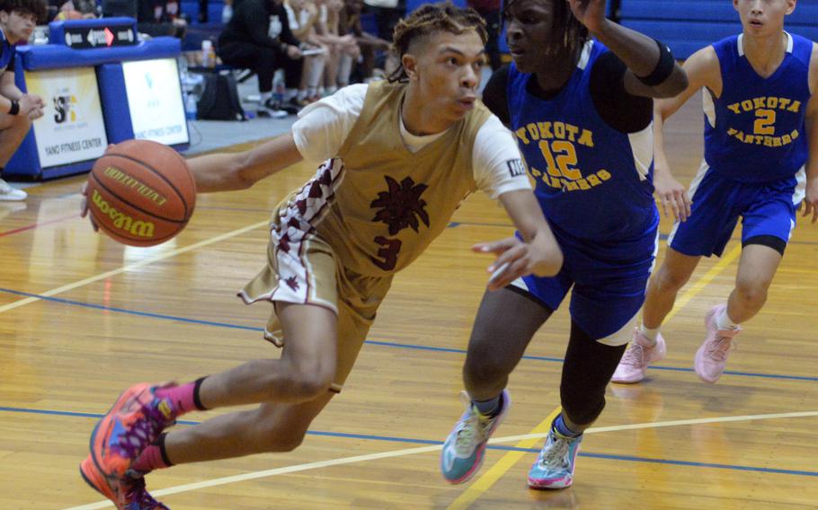 Perry's B.J. Hill drives against Yokota's Jai Bailey.