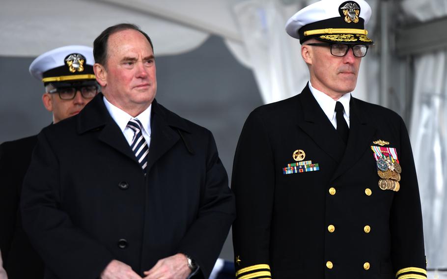 Sailors stand on a podium next to each other