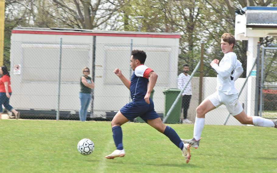 Aviano's Nick Gilbert outraces the rest of the field - including Naples' Andrew Howell - before scoring a goal in the Saints' 3-2 loss to the Wildcats on Saturday, April 16, 2022 in Aviano, Italy.