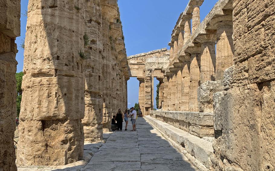 Visitors can enter and explore the Temple of Neptune, one of three temples at the ruins of Paestum in Italy. 