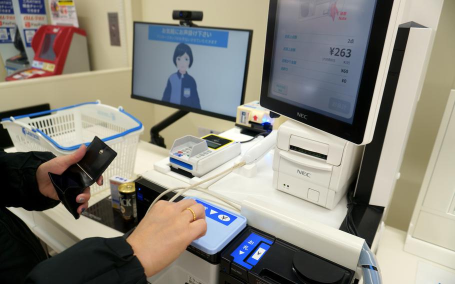 An avatar guides a customer through a transaction at Green Lawson, a new convenience store in Tokyo, Dec. 5, 2022. 