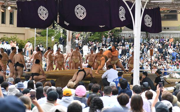 Sumo wrestlers warm up before ahead of their bouts at Yasukuni Shrine in Tokyo, April 14, 2025.
