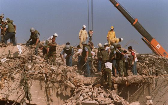 Rescue workers sift through the rubble of the U.S. Marine base in Beirut in Oct. 23, 1983, following a massive bomb blast that destroyed the base and killed 241 American servicemen. Iran told the United Nation’s highest court on Monday, Sept. 19, 2022, that Washington’s confiscation of some $2 billion in assets from Iranian state bank accounts to compensate bombing victims was an attempt to destabilize the Iranian government and a violation of international law. 