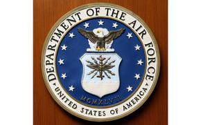 A close-up view of the seal of the Department of the Air Force on a wooden door.