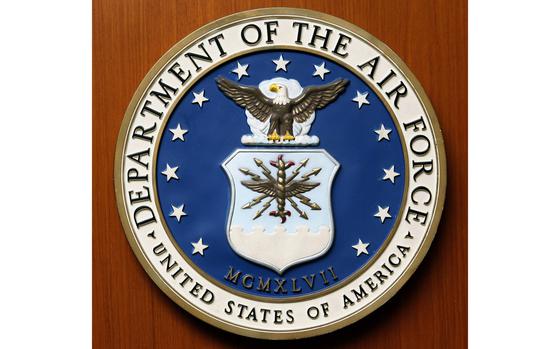 A close-up view of the seal of the Department of the Air Force on a wooden door.