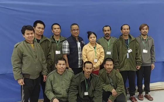 In this photo provided by Thailand's Foreign Ministry, 10 freed Thai hostages pose with an officer, fourth from left, at the Shamir Medical Center in Israel after their release by Hamas militants on Nov. 24.