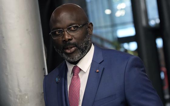 FILE - Liberia President George Weah arrives to attend the Paris Peace Forum, in Paris, France, Nov. 11, 2021. Liberia is celebrating two major anniversaries this year — 200 years ago freed slaves from the U.S. arrived here and 25 years later they declared the country to be independent. Amid the festivities for Independence Day on Tuesday July 26, 2022, many Liberians say the West African country's promise is unfulfilled and too many of its people still live in poverty. (AP Photo/Christophe Ena, File)