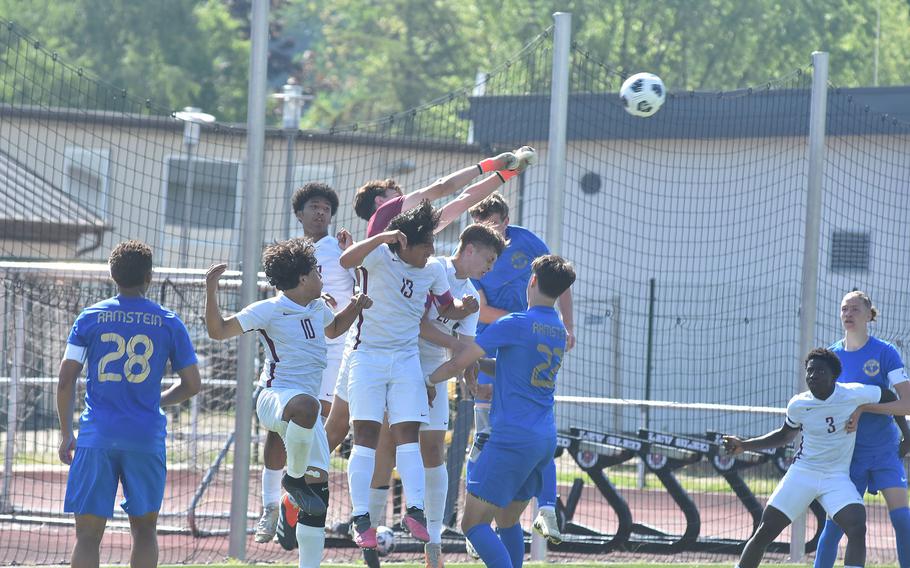 Lakenheath goalkeeper Matthew Vasquez punches the ball away from a crowd of players in the Lancers' 2-0 loss to Ramstein on Monday, May 20, 2024, on the opening day of the DODEA European Division I boys soccer championships at Kaiserslautern High School.