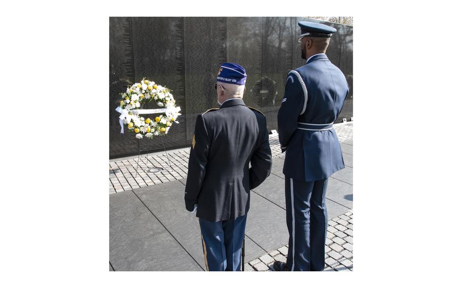 Vietnam veteran Michael Overmeyer and his active-duty escort stand during a wreath-laying ceremony on National Vietnam War Veterans Day in Washington, D.C., March 29, 2024.