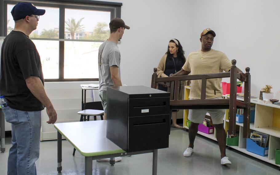 Sailors assigned to Bahrain help restore damaged classrooms April 23, 2024, at the Bahrain Elementary, Middle and High School. More than 35 sailors volunteered to move classroom furniture and expedite repairs. The 24-acre campus in Juffair was closed April 16 following near-record rainfall in the Persian Gulf region.