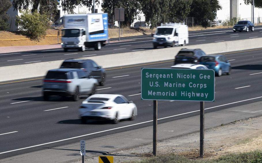 A highway sign is seen inscribed with the words, “Sergeant Nicole Gee U.S. Marine Corps Memorial Highway.”
