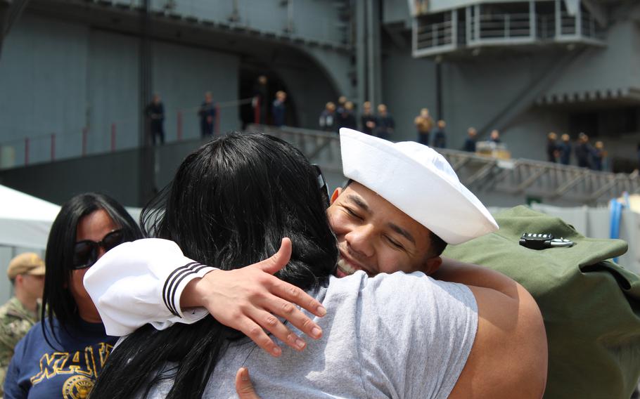 A sailor embraces a loved one