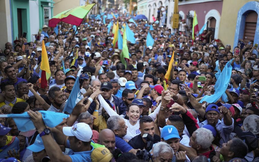 Maria Corina Machado, banned opposition presidential primary candidate for the Vente Venezuela party, center, arrives at a campaign rally in Valencia, Carabobo state, Venezuela, on Thursday, Oct. 5, 2023.