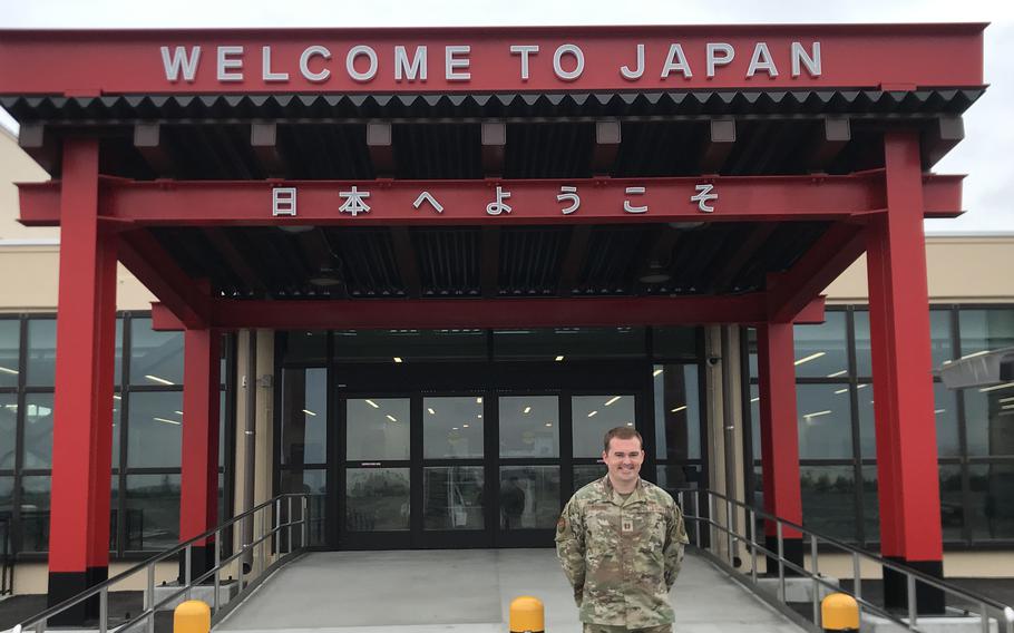 Air Force Capt. Cody Byford, the 730th Air Mobility Squadron logistics and readiness officer at Yokota Air Base, Japan, stands before a torii, part of a $27.5 million renovation of the Yokota Passenger Terminal, on June 16, 2022. 
