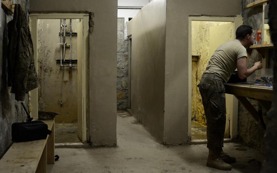 Pfc. Santiago Ramos shaves before going to work for the day at Combat Outpost Sabari, Khost province.