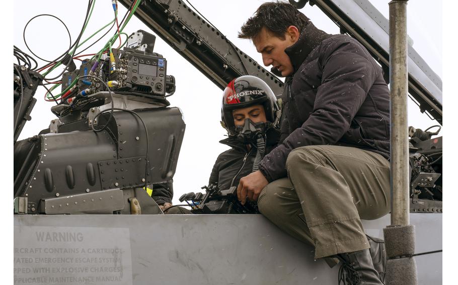 Monica Barbaro, left, and Tom Cruise on the set of "Top Gun: Maverick." 