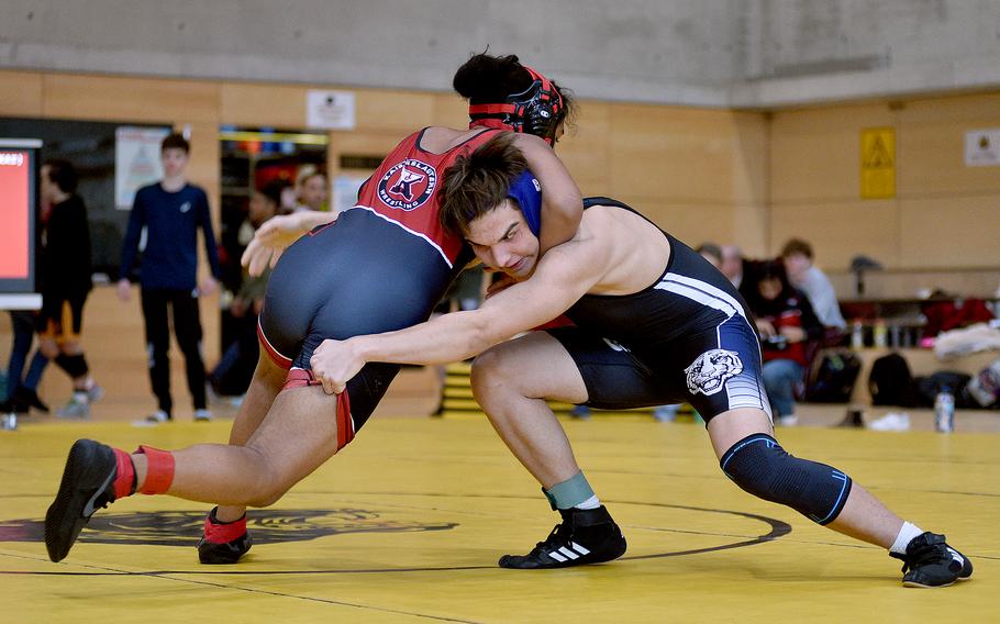 Hohenfels' Julian Yazzie reaches out for Kaiserslautern's Noah Wagner in a 165-pound match during a DODEA wrestling sectional meet on Feb. 3, 2024, at Stuttgart High School in Stuttgart, Germany.