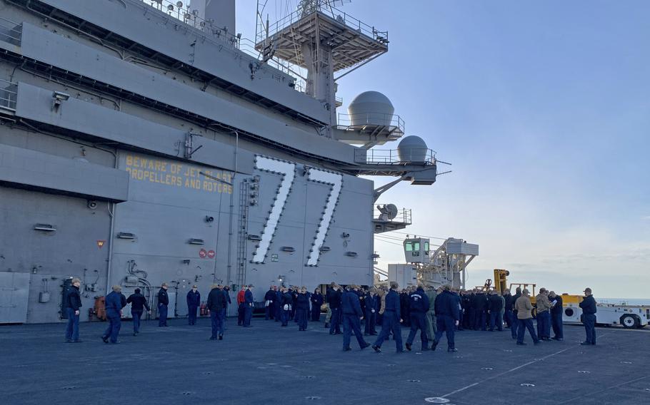 Sailors gather on the flight deck of the USS George H.W. Bush on Nov. 29, 2022. The aircraft carrier, on duty in the Mediterranean Sea since August, recently sailed with carrier strike groups from France and Italy in the Ionian Sea in a show of NATO solidarity and strength. 