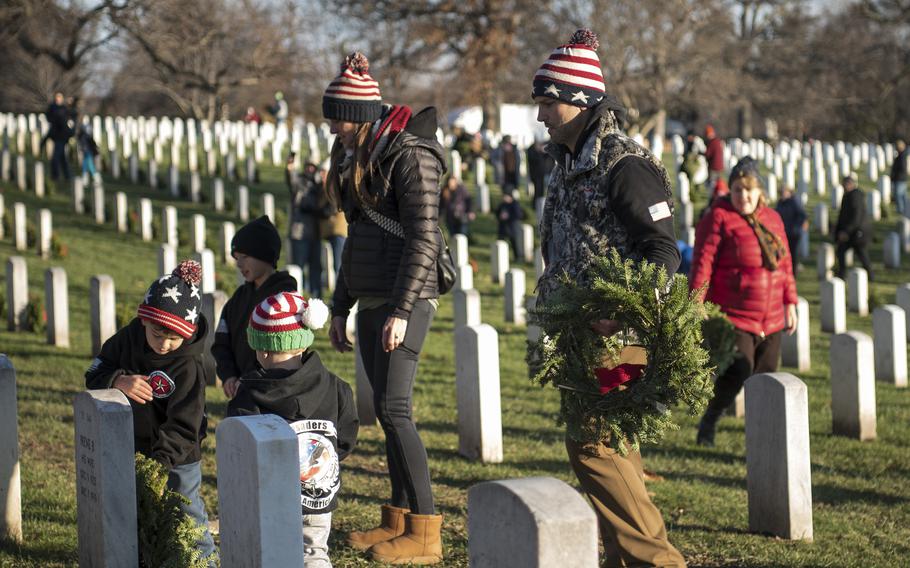 Navy Reserve Lt. Cmdr. Tyler Lavrerick and his wife Jessica brought their four children –Regan, Max, Cole and Nick – to Arlington National Cemetery on Saturday, Dec. 17, 2022, to take part in the Wreaths Across America event honoring military veterans who have served their country.