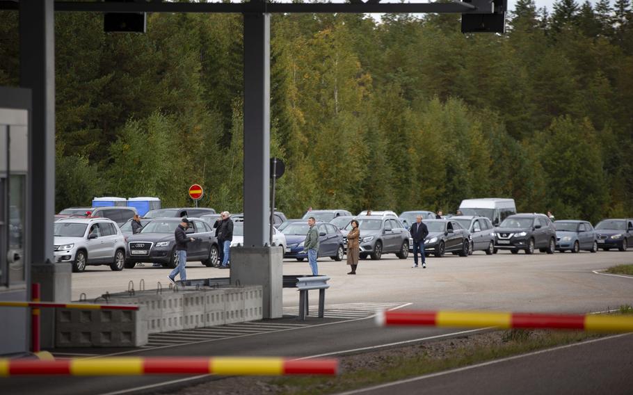 Cars queue to cross the border from Russia to Finland at the Vaalimaa border check point in Virolahti, Finland, Friday Sept. 23, 2022.