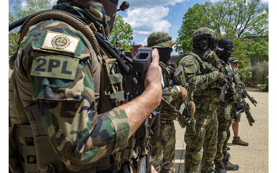 Armed members of the New England Minutemen militia attend a rally in Concord, N.H., on May 15, 2021.