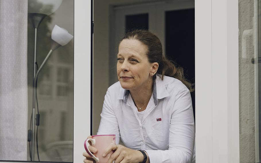 Birgit Brombacher looks out of a window at her home in Schwetzingen, Germany. 