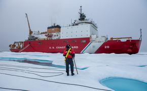 A member of the ice rescue team maintains look-out as U.S. Coast Guard Cutter Healy (WAGB 20) keeps station alongside a multi-year ice floe for a science evolution on in the Beaufort Sea, Aug. 9, 2023. Healy is the Coast Guard’s only icebreaker specifically designed for Arctic research, as well as the nation’s sole surface presence routinely operating in the Arctic Ocean. (Coast Guard photo by Petty Officer 3rd Class Briana Carter)